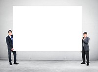 Smiling businessman holding blank billboard