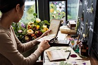 Woman looking a dried flower book