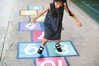 Kid playing hopscotch at school