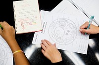 High school students hands working on cell anatomy work sheet