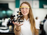 High school student hand holding molecul structure in chemistry class