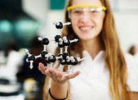 Female student holding a molecule model