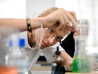 Male student doing a science experiment in the laboratory 