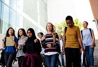 Diverse group of students walking in school 