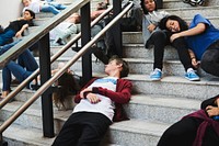 Young students sleeping on the staircase