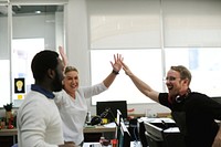 Diverse colleagues with high five