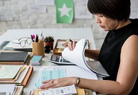 Asian woman working on invoices 