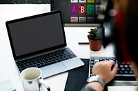 Laptop Screen Showing Black Desktop on Whtie Table beside Working Man