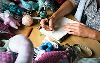Closeup of hands drawing doll pattern handicraft