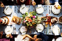 Groom kissing bride hand in wedding reception aerial view