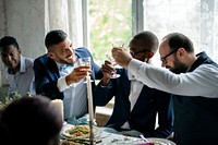 People holding their champagne glasses for a toast at a wedding table