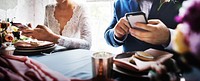 Newlywed couple using mobile phone