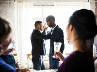 Gay Couple Arms Crossed Drinking Champagne Together