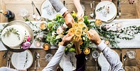 An aerial view of wedding guests doing a toast at the table