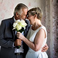 Senior Couple with White Roses Flower Bouqet