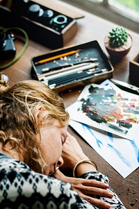 Closeup of artist woman taking a nap on work table