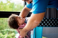 Dad picking up cheerful baby girl