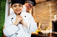 Young cheerful girl in chef uniform