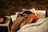 Couple spooning and sleeping in bed