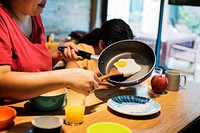 Mother preparing breakfast at dining table