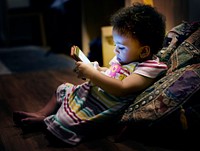 Little toddler girl using mobile phone