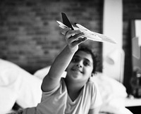 Young girl playing with airplane toy