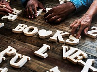 Diverse hands spell out books 