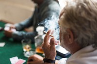 Adults socialising and playing cards 