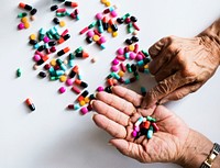Closeup of hands taking pills health treatment isolated