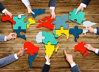 Business People Forming World Map with Puzzle Pieces
