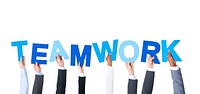 Business People Arms Raised and Holding the Word Teamwork