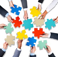 Group of Hands Holding Jigssaw Puzzle