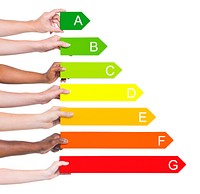 Multi-ethnic people holding energy graph.