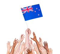 Human hand holding New Zealand Flag among group of multi-ethnic hands
