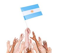 Human hand holding Agentina flag among multi-ethnic group of people's hand