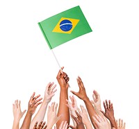 Human hand holding Brazil Flag among multi-ethnic group of people's hand