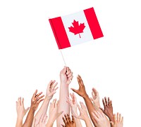 human hand holding Canada flag among multi-ethnic group of people's hands
