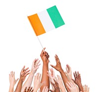 Group Of Multi-Ethnic People Reaching For And Holding The Flag Of Cote D'Ivoire