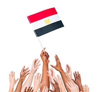 Group of multi-ethnic people reaching for and holding the flag of Egypt.