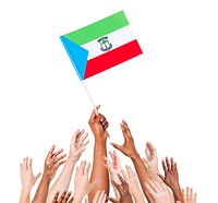 Group Of Multi-Ethnic People Reaching For And Holding The Flag Of Equatorial Guinea