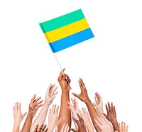 Group of multi-ethnic people reaching for and holding the flag of Gabon.