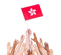 Group of multi-ethnic people reaching for and holding the flag of Hong Kong.