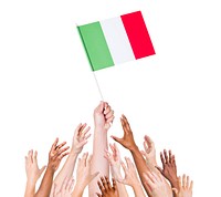 Group of multi-ethnic people reaching for and holding the flag of Italy.