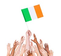 Human hand holding Ireland Flag among multi-ethnic group of people's hand