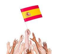 Group of multi-ethnic people reaching for and holding the flag of Spain.
