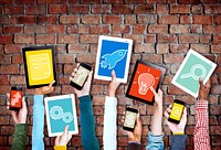 Group of Hands Holding Digital Devices with Symbols
