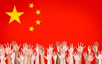 People's Hands Raised with Chinese Flag on the Background