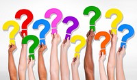 Multi-Ethnic group of human hands holding question marks.