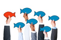 Business People Holding Fish Symbol and Contrasts Concept