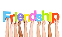 Multi Ethnic People Holding The Word Friendship